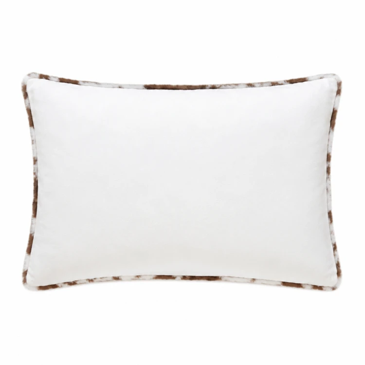 Coussin garni à motif peau de vache et dos en velours