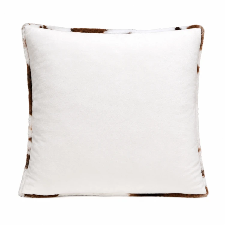Coussin garni à motif peau de vache et dos en velours
