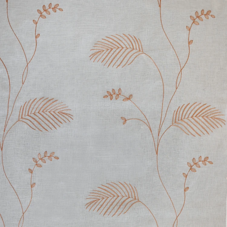 Tissu voilage brodé motif feuilles avec bas plombé